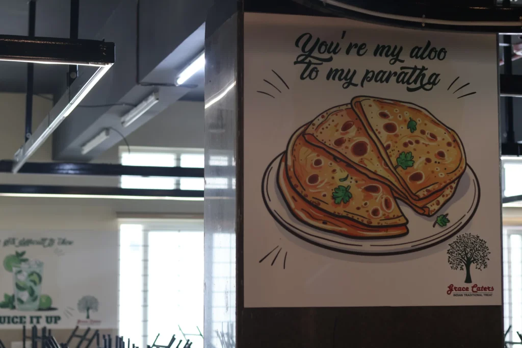 Signage — “aloo to my paratha” panel on a stall column