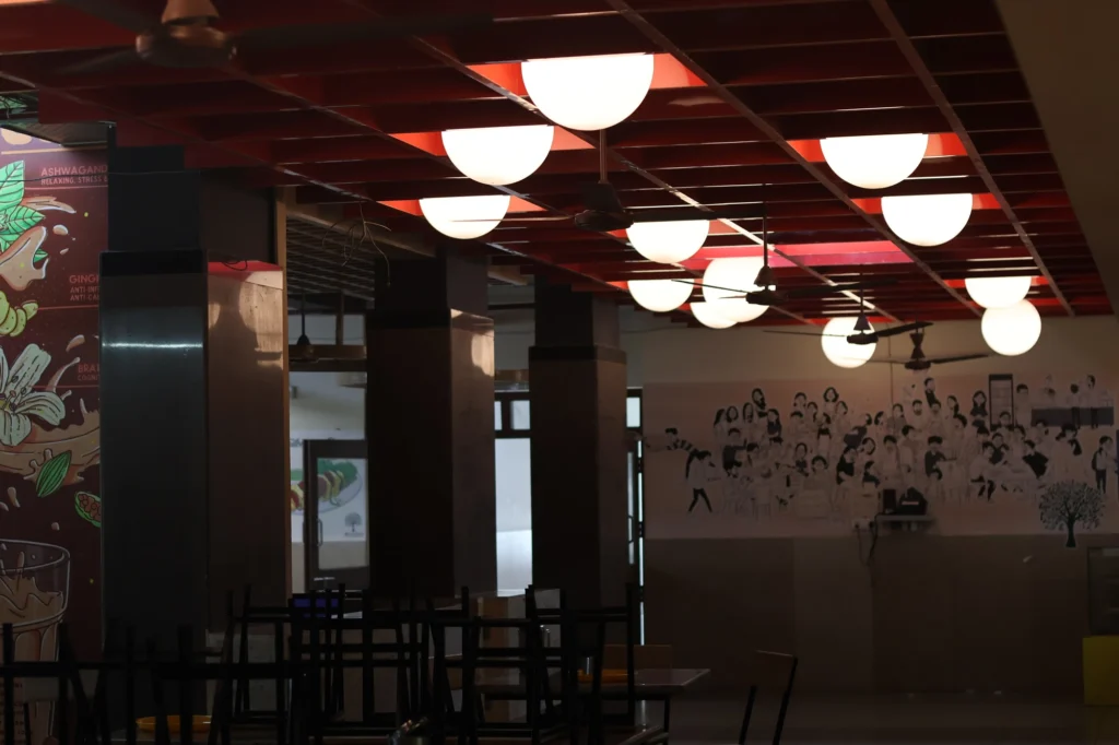 As built — the spice-and-chai mural bay beneath the columns