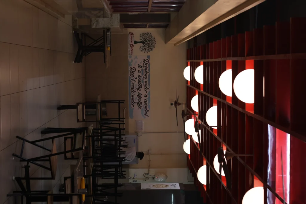 As built — the glowing red-batten ceiling over the Grace Caters tree mark