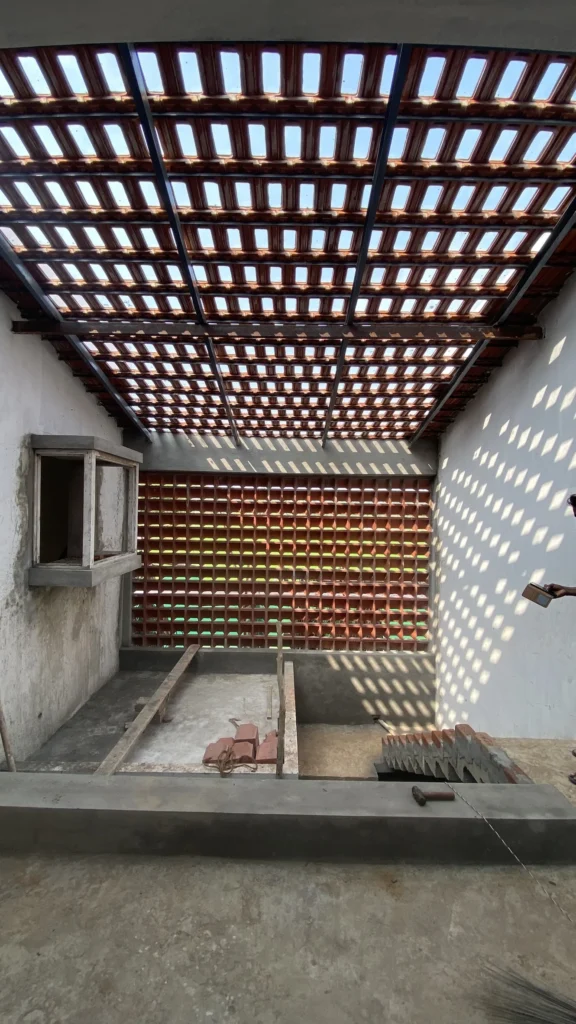 Double-height court under the tiled pergola and clay screen