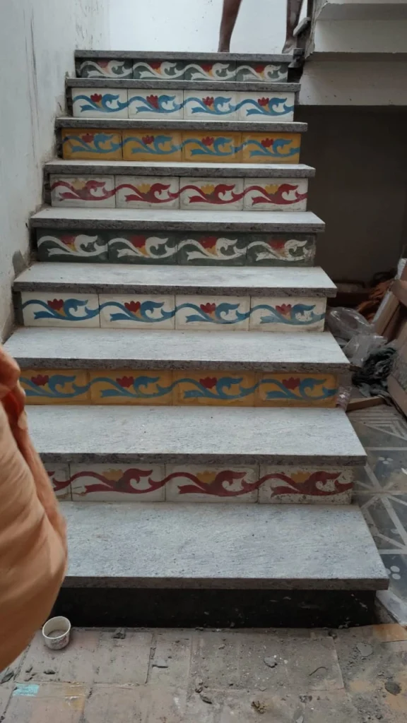 Hand-painted tile risers on granite treads